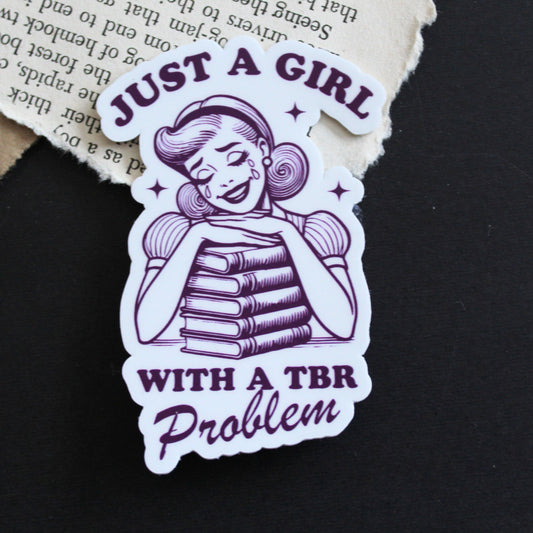 Sticker with a design of a girl with books and text 'Just a Girl with a TBR Problem' 